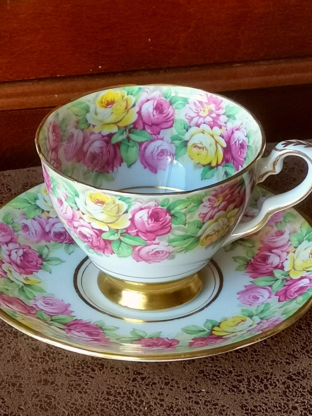 Footed Gold Trim Bone China Teacup And Saucer w/ Pink & Yellow Rose Pattern